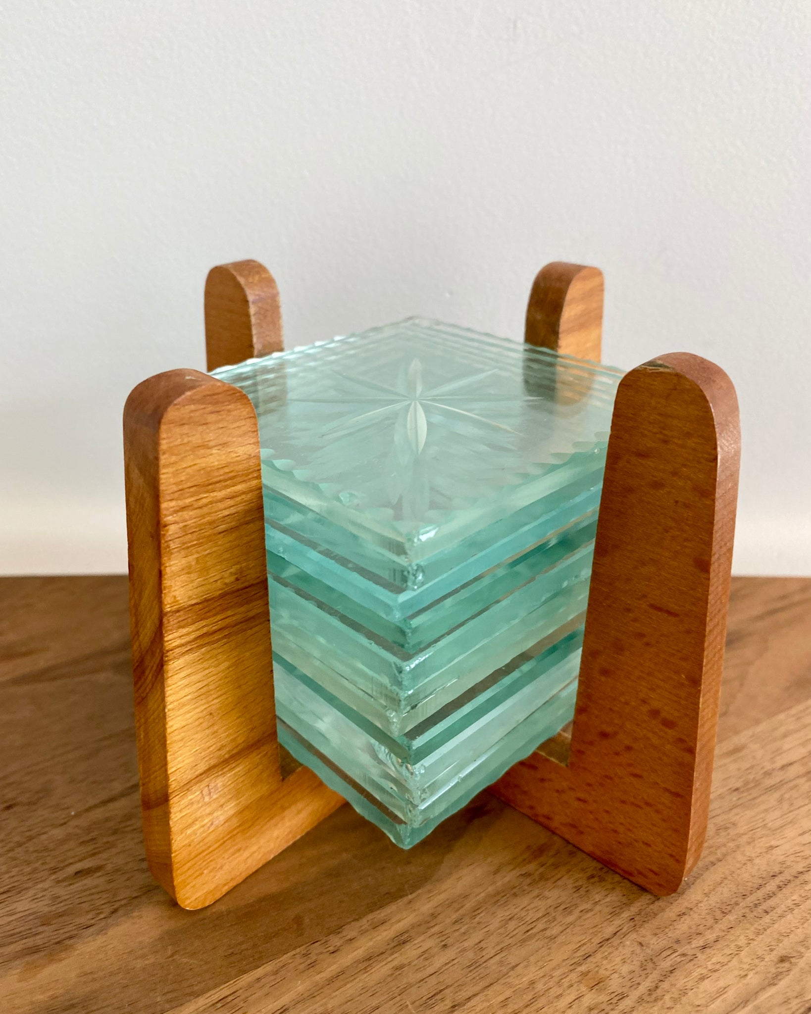 Set of 12 glass coasters with wooden holder