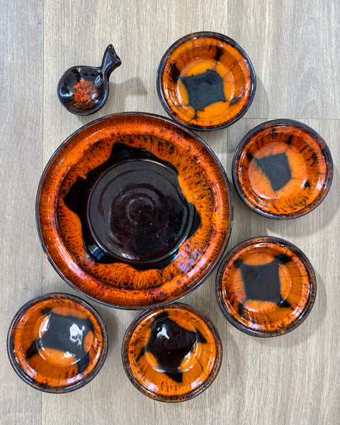 Brown or almost black ceramics and orange drip snack set