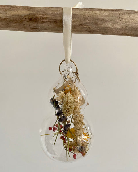Glass Christmas decorations with dried flowers